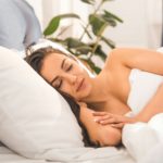 beautiful woman sleeping in bed at home in morning