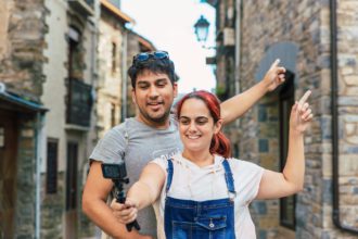 Young couple vlogging and recording a video while doing rural tourism in a mountain village